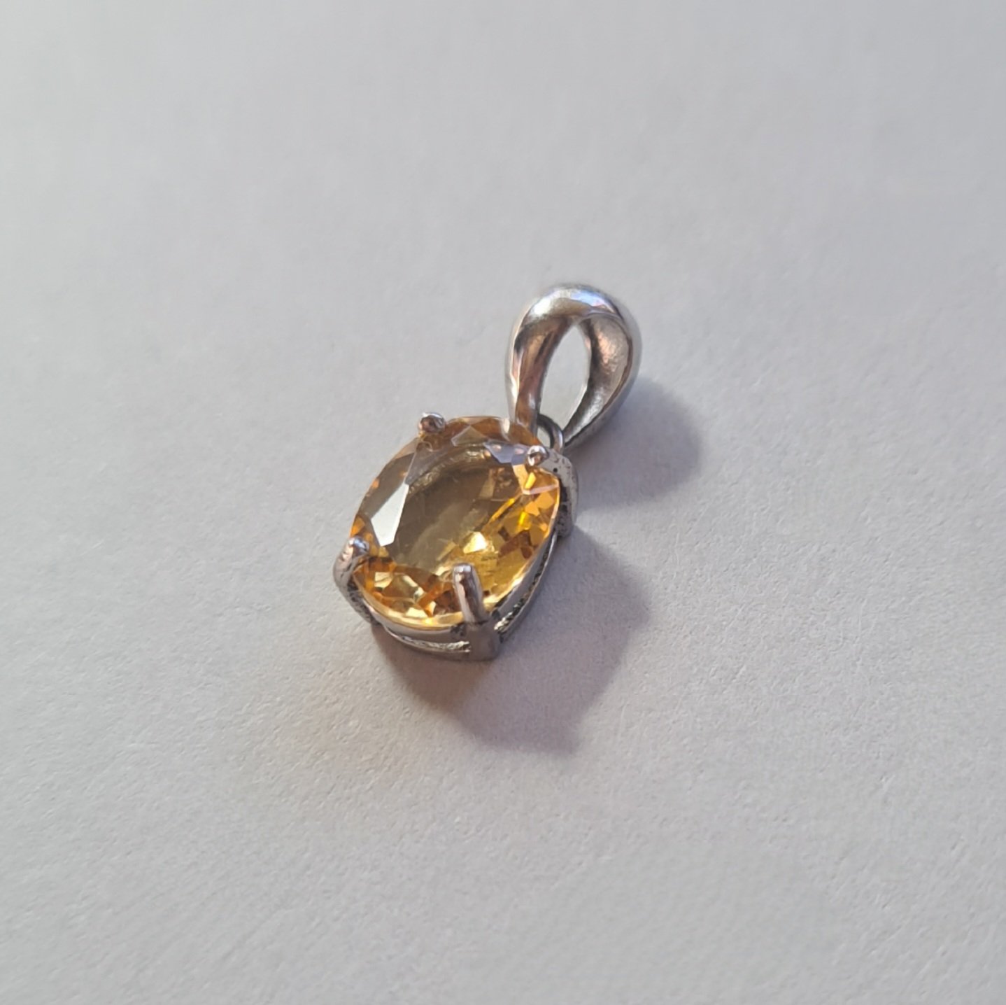 Jemagic citrine pendant on silver background - side view Jemagic citrine pendant on silver background - side view