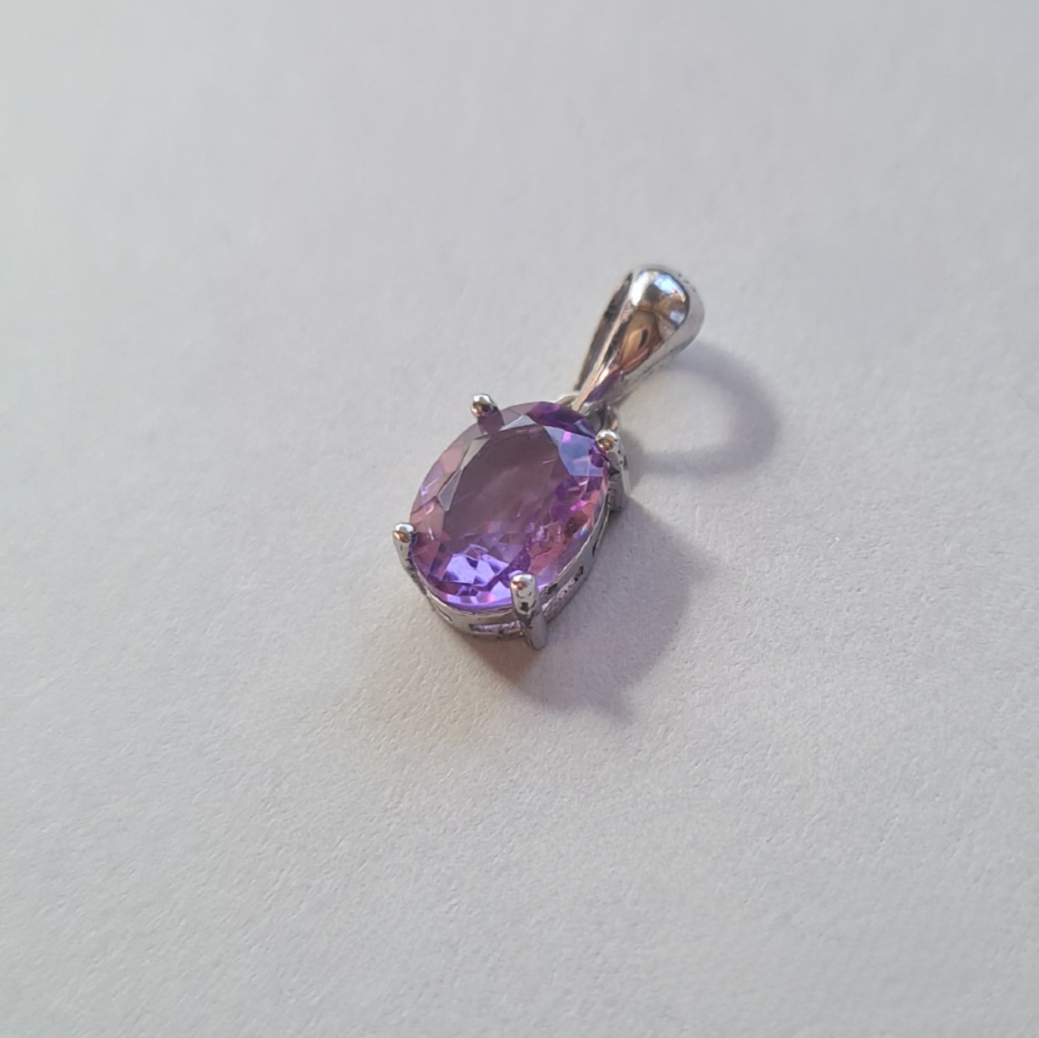 Jemagic amethyst pendant on silver background - side view Jemagic amethyst pendant on silver background - side view