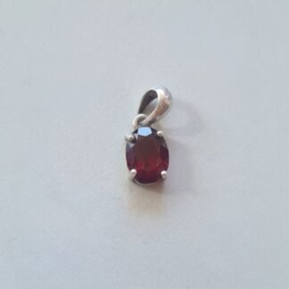 Jemagic garnet pendant on silver background