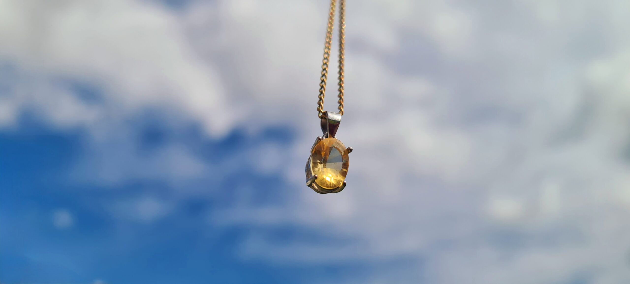 A Jemagic citrine pendant with a cloudy sky BG