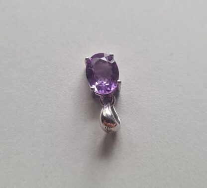 Jemagic amethyst pendant on silver background - Top View