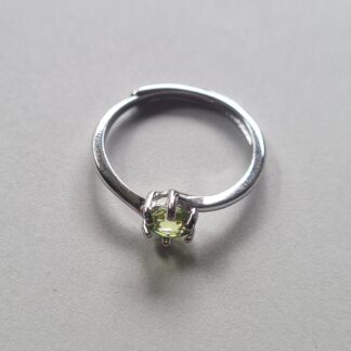 Jemagic peridot ring on silver background