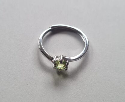 Jemagic peridot ring on silver background