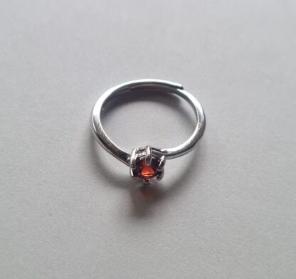Jemagic garnet ring on silver background