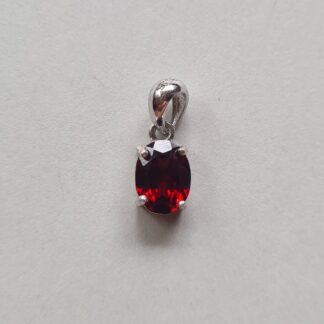 Jemagic garnet pendant on silver background