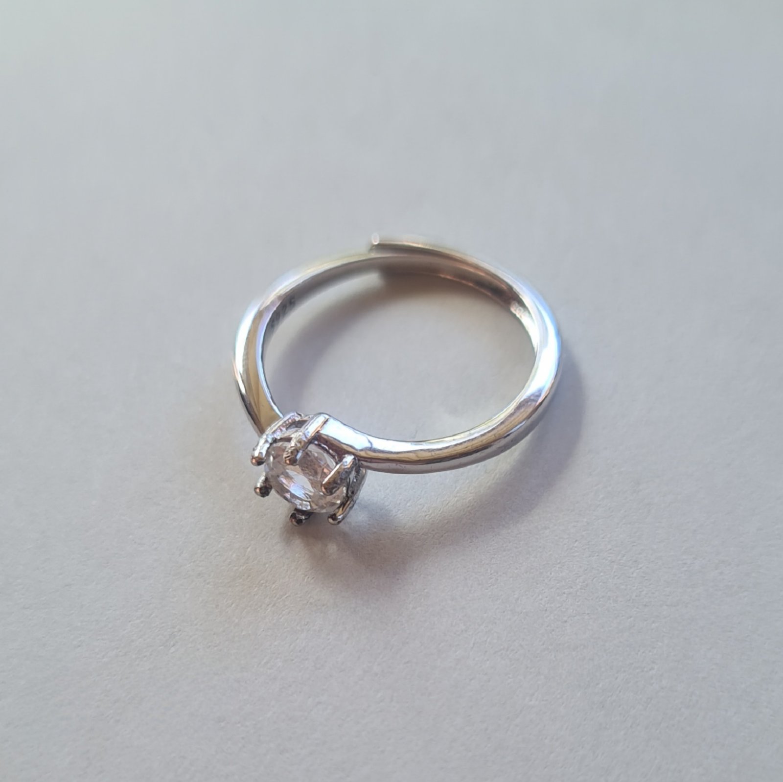 5mm Jemagic white topaz ring on silver background - side view 5mm Jemagic white topaz ring on silver background - side view