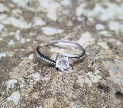 Jemagic White Topaz Ring on Rock Background