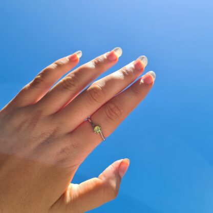 Jemagic Peridot Ring being worn with blue sky background