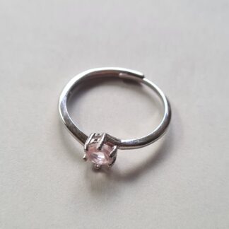 Jemagic rose quartz ring on silver background