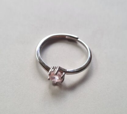 Jemagic rose quartz ring on silver background