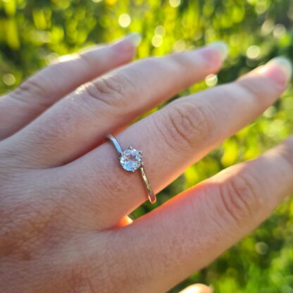 Wearing a Jemagic White Topaz Ring with a Blurred Tree Background at Sunset