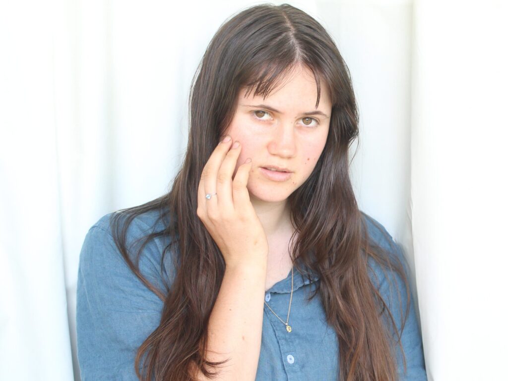 Woman wearing Jemagic topaz ring and citrine necklace