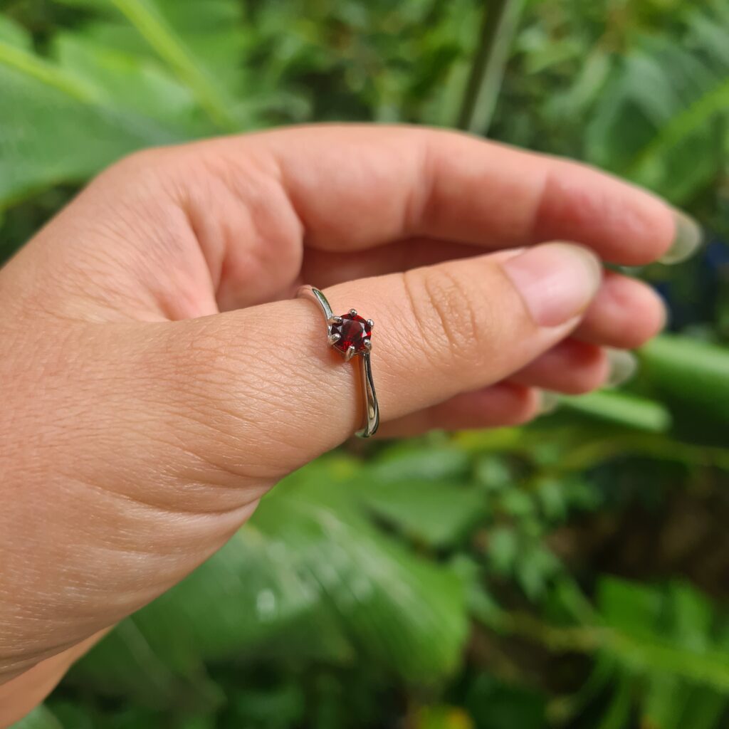 Jemagic garnet ring on thumb