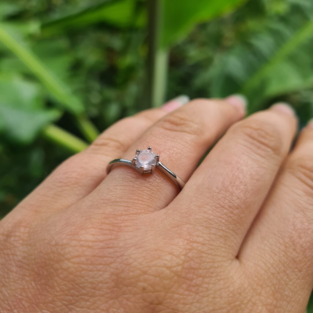 Jemagic rose quartz ring on ring finger