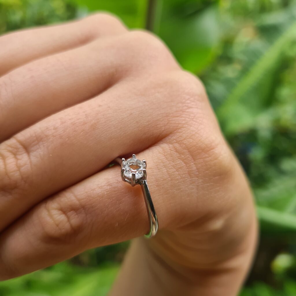 Jemagic white topaz ring on pinky finger