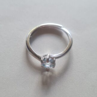 Jemagic blue topaz ring on silver background