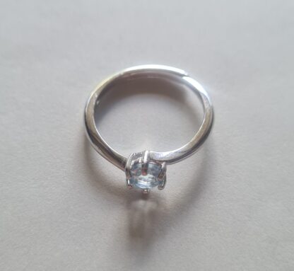Jemagic blue topaz ring on silver background
