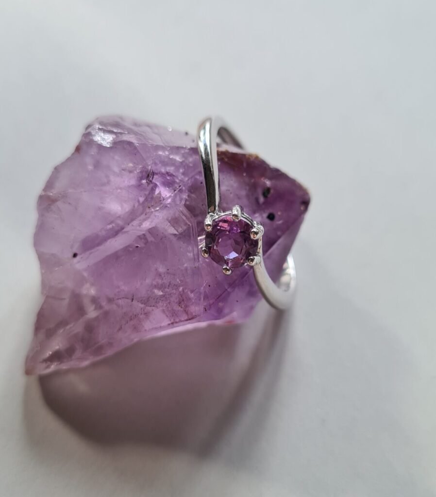 Jemagic amethyst ring on pointed amethyst crystal