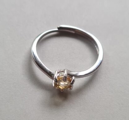 Jemagic citrine ring on silver background.