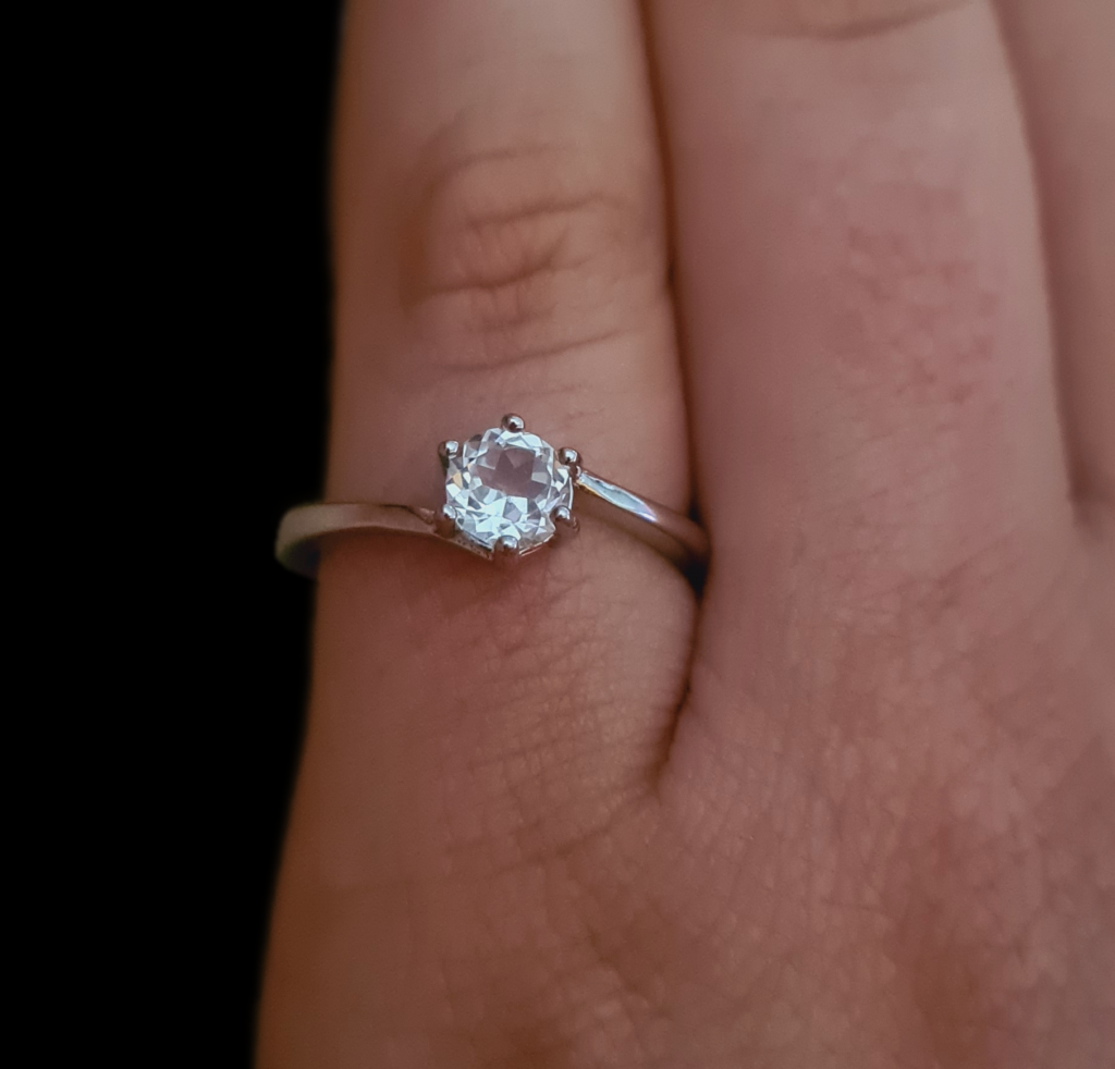 Jemagic white topaz ring on pinky finger