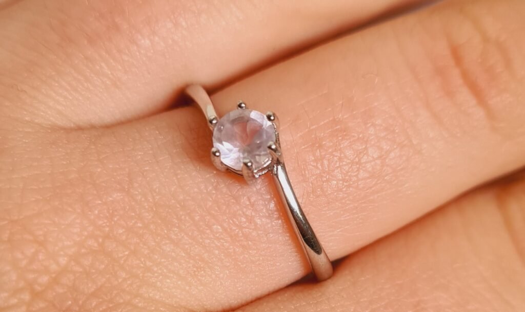 Close up Jemagic rose quartz ring on finger