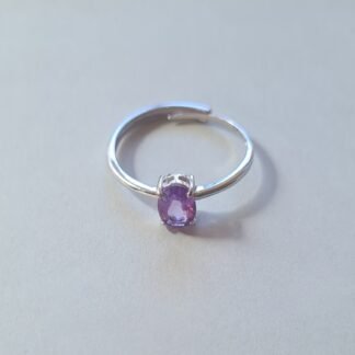 oval cut Jemagic amethyst ring on silver background