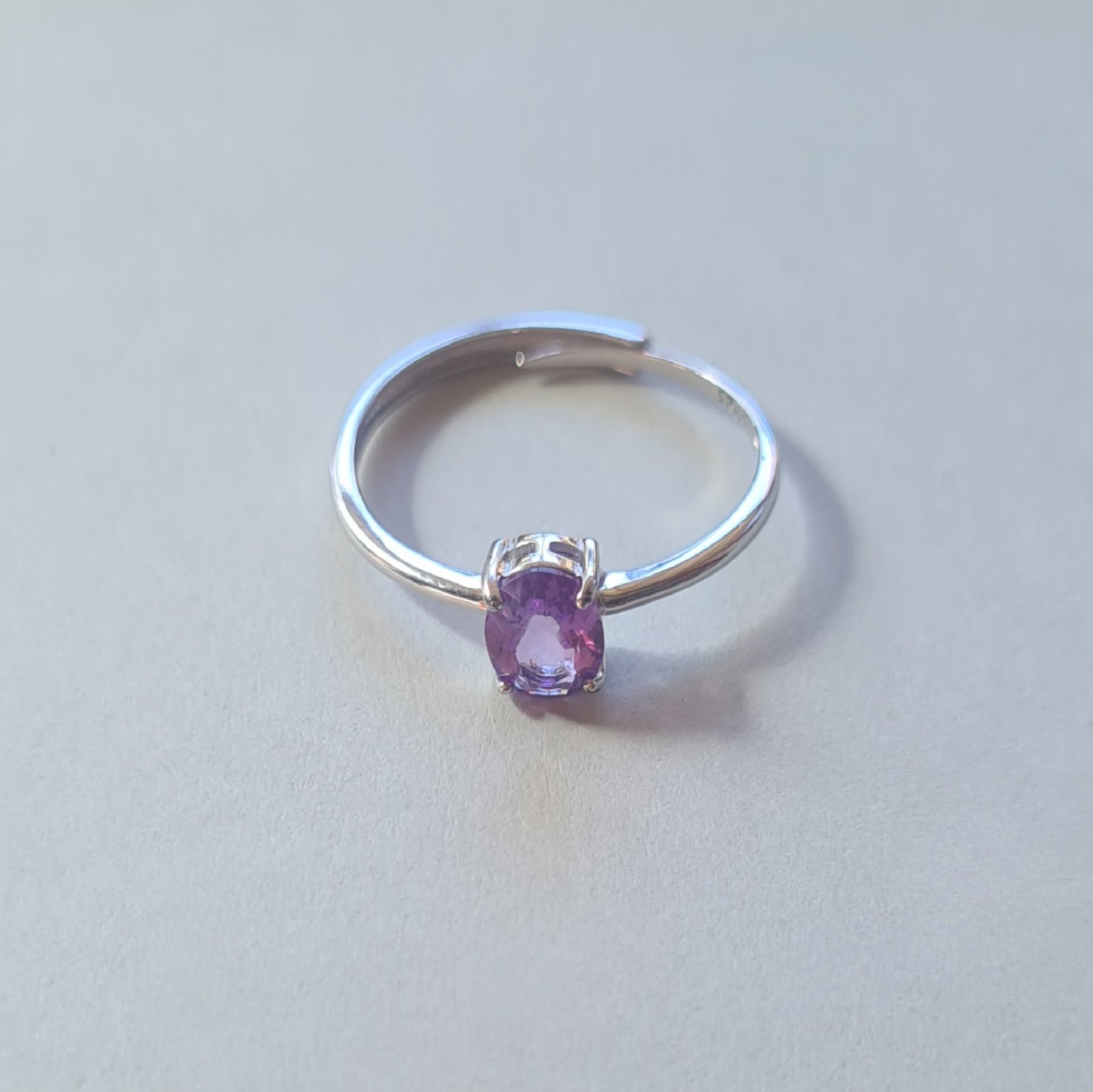 oval cut Jemagic amethyst ring on silver background oval cut Jemagic amethyst ring on silver background