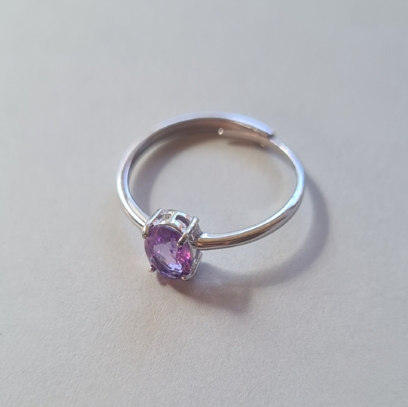 oval cut Jemagic amethyst ring on silver background - side view oval cut Jemagic amethyst ring on silver background - side view