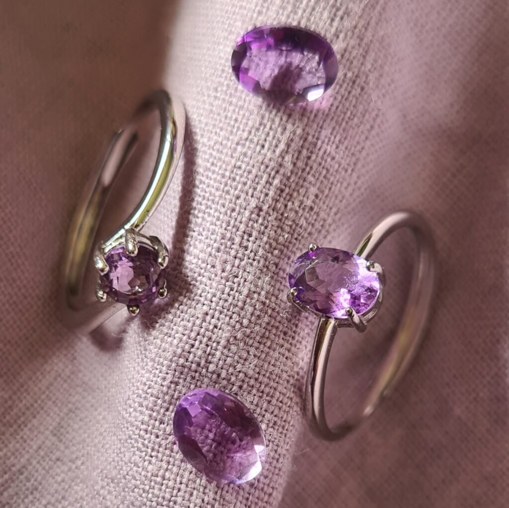 Jemagic Instagram post featuring Jemagic amethyst rings and loose amethyst gemstones on a light purple linen background
