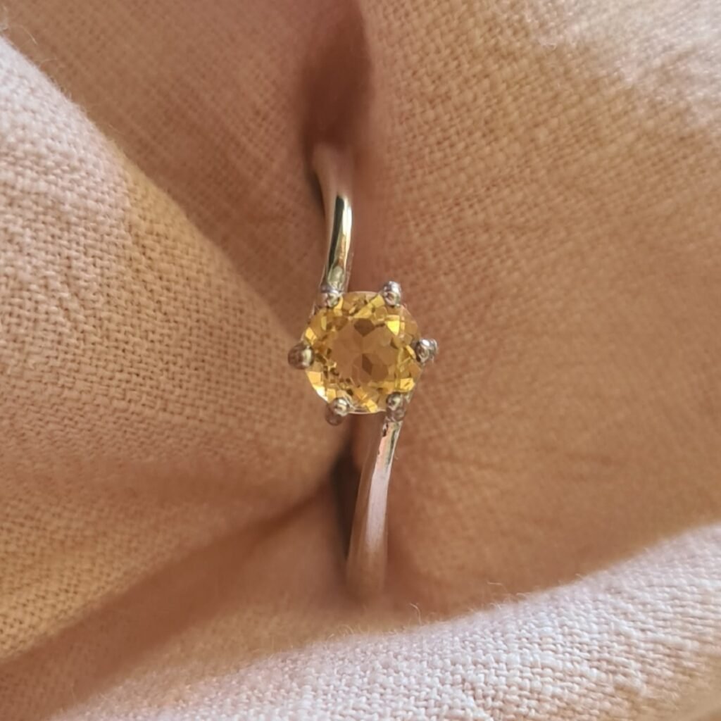 Jemagic Instagram post featuring a round cut citrine ring with pink linen background