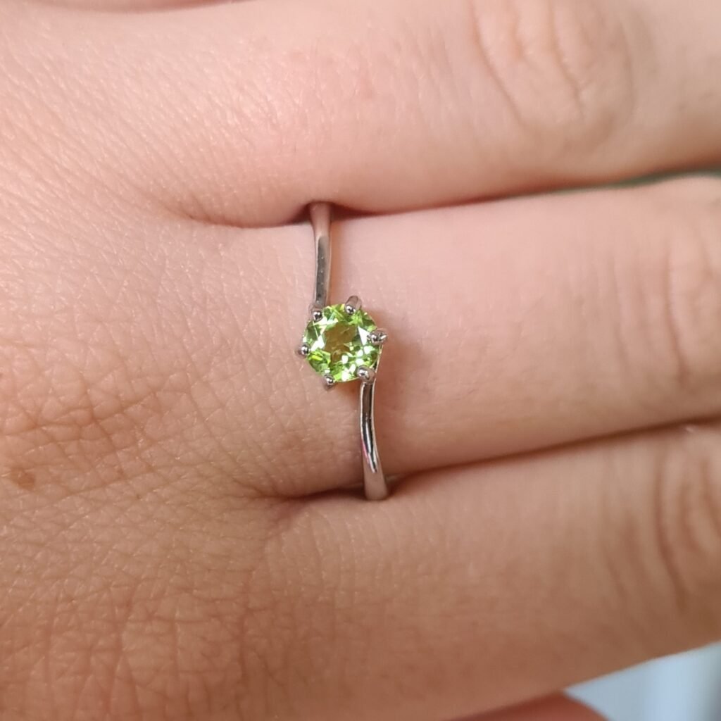 Jemagic Instagram post featuring a round cut peridot ring on finger